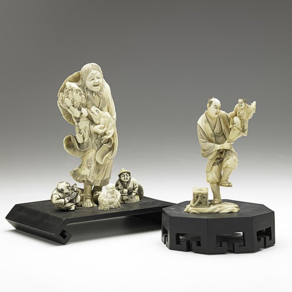 TWO ASIAN IVORY CARVINGS: TWO ASIAN IVORY CARVINGS; Older woman surrounded by netsuke and man holding a smaller male figure in his arms, both on wood bases, 19th/20th c.; Taller: 7'' (without base) Note: International bids and