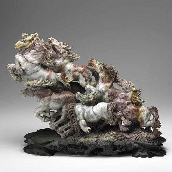 AFTER HUANG JI: AFTER HUANG JI; Red soapstone carving of a herd of stampeding horses on wood base, 20th c.; Unsigned; 15'' x 21'' x 8''