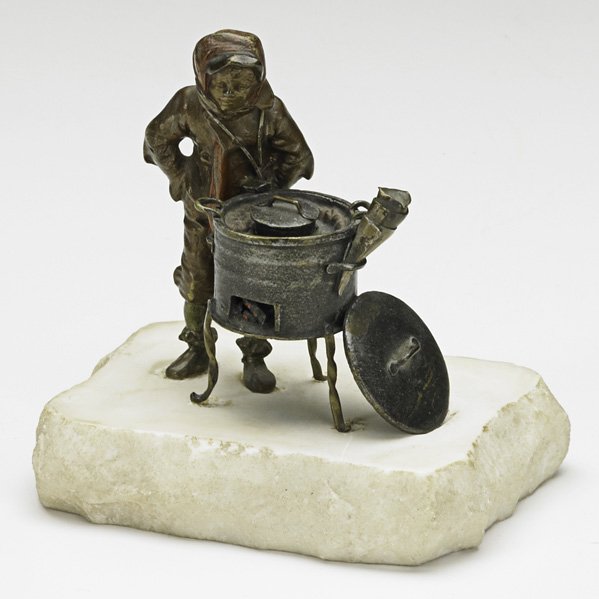 FRANZ XAVIER BERGMAN (Austrian, 1861-1936): FRANZ XAVIER BERGMAN (Austrian, 1861-1936); Boy selling chestnuts on white marble base, 20th c.; Signed; 4 1/2'' x 4 1/2'' x 3''; Literature: Illustrated in ''Vienna bronze: a Viennese Tradition in Ar