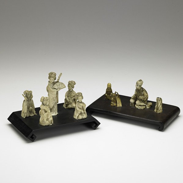 ASIAN IVORY CARVINGS: ASIAN IVORY CARVINGS; Two figural groups mounted on wood bases, 20th c.: one a central female figure surrounded by seated women, the other a male with paint brush surrounded by three other figures; Ta