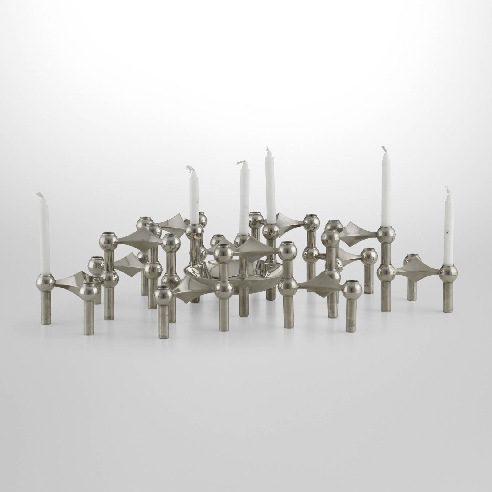 Caesar Stoffi, Candleholders, set of thirteen: Caesar Stoffi Candleholders, set of thirteen Nagel AGGermany, c. 1965nickel-plated brass each candleholder: 2.75 h x 4.5 w x 4.5 d in (7 x 11 x 11 cm) tray: 2 h x 5.5 dia in (5 x 14 cm) <