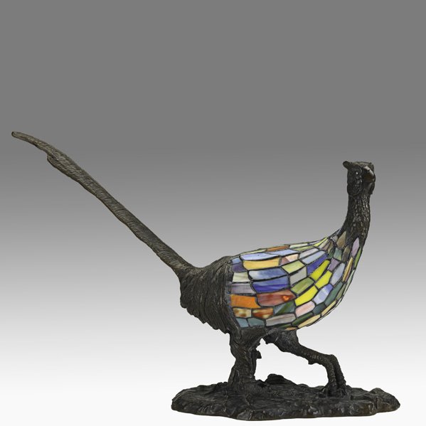 CHARLES SCHNEIDER Rare bronze and glass lamp: CHARLES SCHNEIDER Rare pheasant lamp, France, ca. 1910; Patinated bronze, leaded slag glass, single socket; Signed in bronze mold; 17" x 24" x 9"
