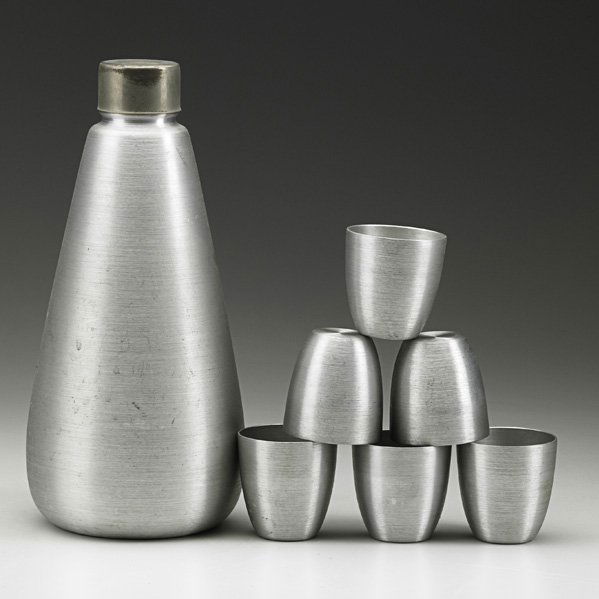 RUSSEL WRIGHT Cocktail shaker and cups: RUSSEL WRIGHT Cocktail shaker and six cups, USA, 1930s; Spun aluminum; Each piece stamped RUSSEL WRIGHT; Shaker: 11" x 5", tumblers: 2 1/2" x 2 1/4"