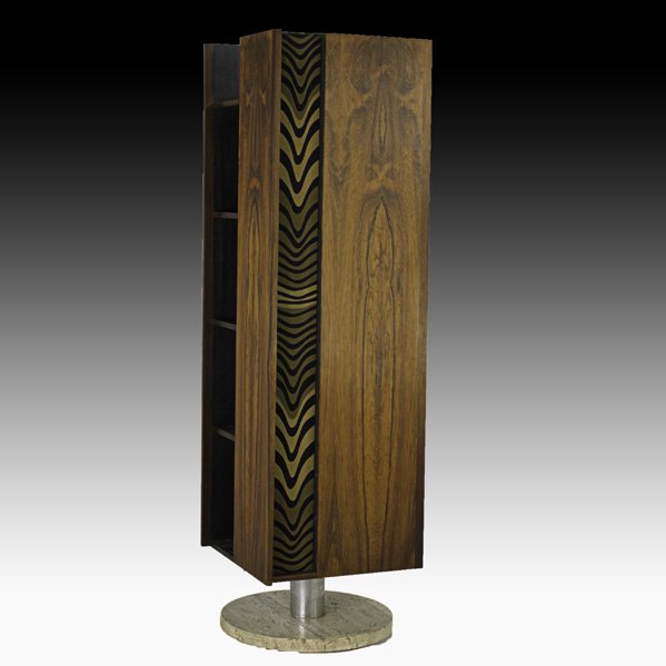 VLADIMIR KAGAN Revolving bookcase: VLADIMIR KAGAN KAGAN-DREYFUSS Revolving bookcase, New York, 1960s; Rosewood, travertine, aluminum, Jack Lenor Larsen stretch fabric; Unmarked; 73 1/2" x 21 1/2" sq.