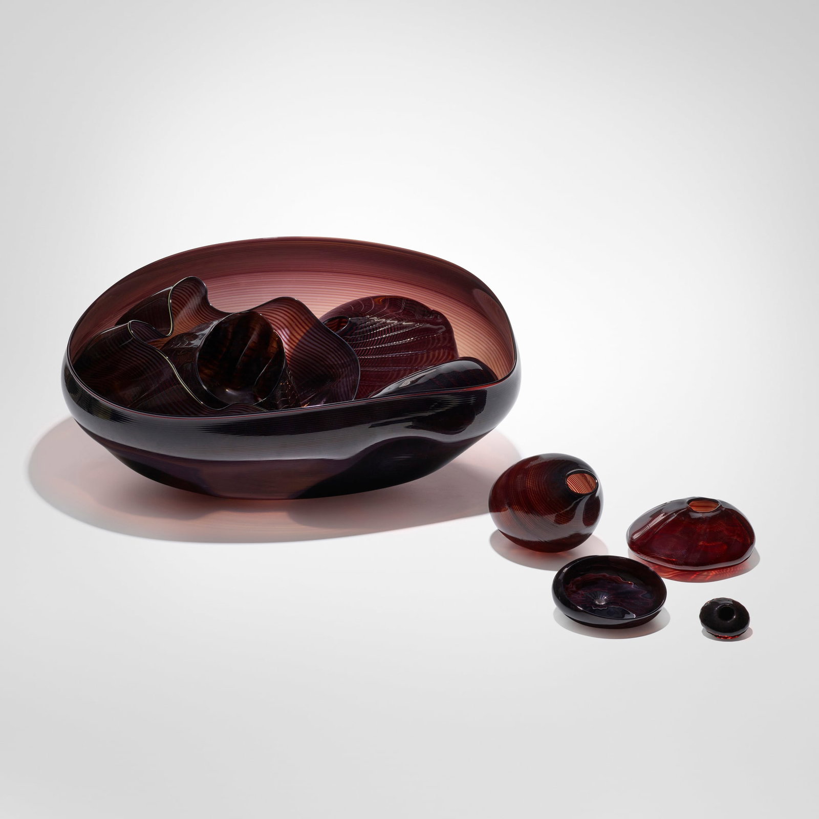 Dale Chihuly, Black Seaform set: Dale Chihuly Black Seaform set USA, 1981 hand-blown glass overall: 7 h x 18 w x 18 d in (18 x 46 x 46 cm) largest: 7 h x 18 w x 18 d in (18 x 46 x 46 cm) smallest: 1 h x 1.75 w x 2 d in (3 x 4 x