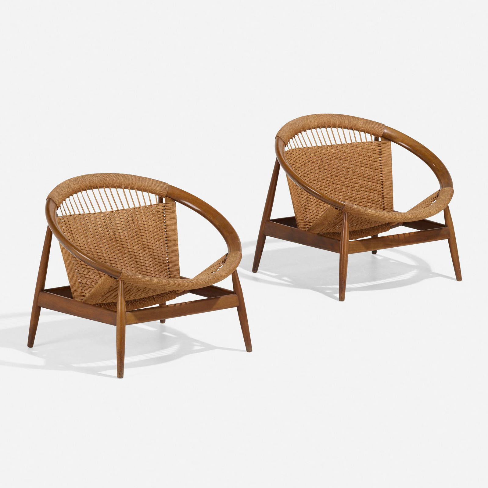 Illum Wikkelso, Ringstol lounge chairs: Illum Wikkelso Ringstol lounge chairs Niels EilersenDenmark, c. 1965walnut, rope each: 26.5 h x 31.5 w x 26 d in (67 x 80 x 66 cm) Stamped manufacturer's mark to underside of one example