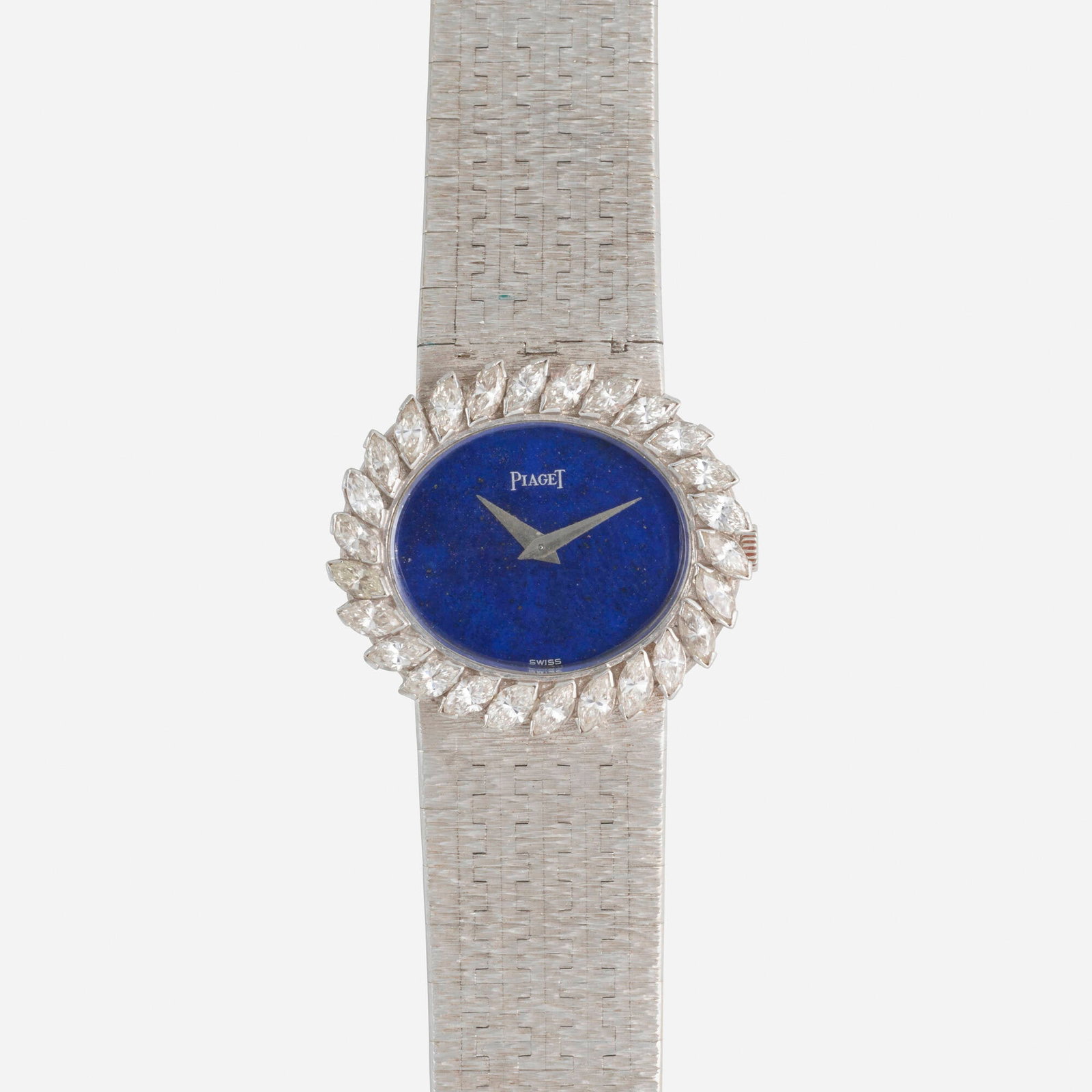 Piaget, Lapis lazuli, diamond, gold wristwatch: Piaget Lapis lazuli, diamond, and white gold wristwatch With sword-shaped hands, a marquise-cut diamond bezel, to the textured white gold braceletDate: 1960s Dial: Lapis lazuli Movement: