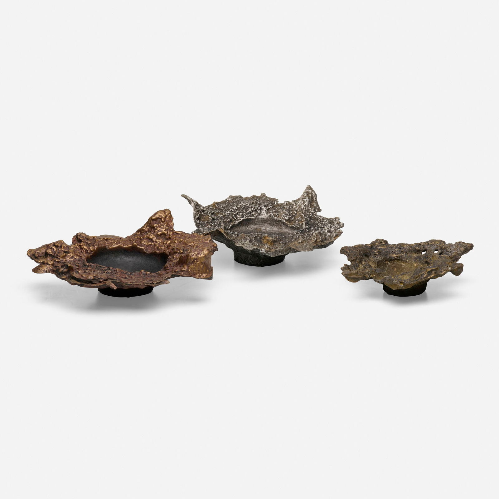 Paul Evans, Collection of three freeform ashtrays: Paul Evans Collection of three freeform ashtrays Paul Evans StudioUSA, c. 1965cast and patinated bronze, bronze composite, aluminum two examples: 3.5 h x 11 dia in (9 x 28 cm) one example: 2