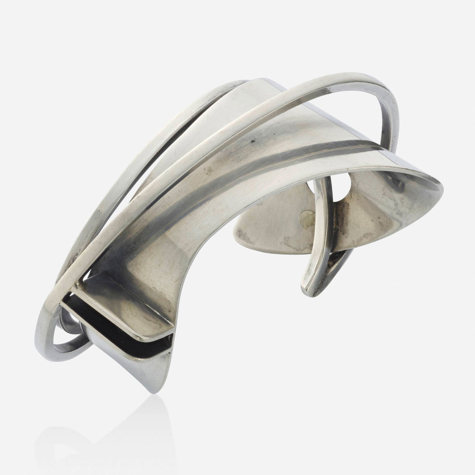 Ed Wiener, Sterling silver cuff bracelet: Ed Wiener Sterling silver cuff bracelet Of abstract design; 1950s Sterling silver Signed Ed Wiener Inner circ. 6.25 in, width 1.25 in; Gross weight 35.0 dwts This work will s