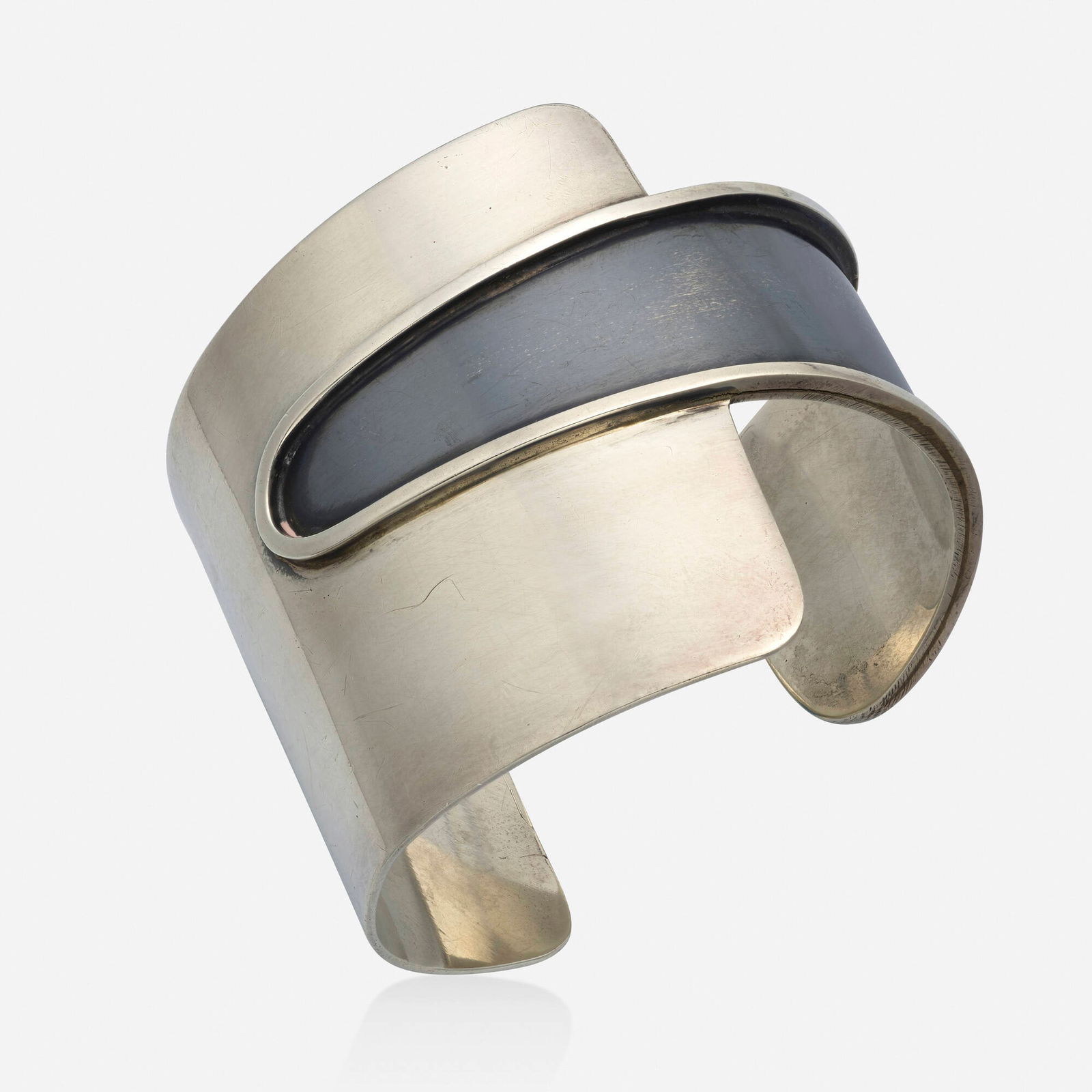 Ed Wiener, Sterling silver cuff bracelet: Ed Wiener Sterling silver cuff bracelet Of abstract design, with a blackened silver strip; 1950s Sterling silver Signed Ed Wiener Inner circ. 6.25 in, width 2.25 in; Gross weight 38.7 dwts