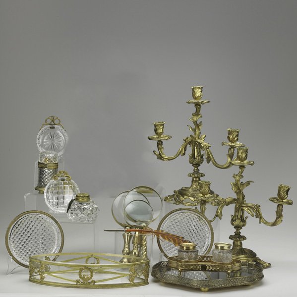 DESKTOP ACCESSORIES: Fourteen items include pair of dore bronze candelabra, (3) brass magnifying glasses, dore bronze and glass ink and powder set, (2) crystal ashtrays, etc., 19th/20th c.; Tallest: 12 1/2"