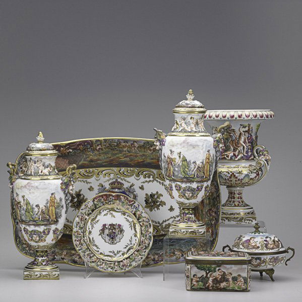 CAPODIMONTE: Seven hand-painted items, 19th/20th c.: armorial platter, pair of covered urns, footed handled trinket box, rectangular trinket box, armorial plate and open two-handled urn; Tallest: 13 1/2"
