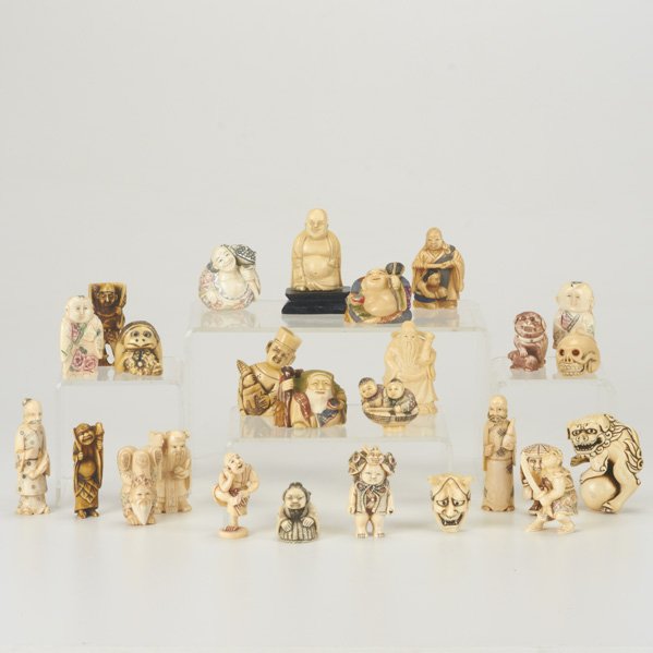 IVORY NETSUKES AND FIGURES: Twenty-six polychrome decorated, 20th c.: figure of a man and toad, netsuke rat on a skull, netsuke Foo dog on a ball, etc.; Some signed; Tallest: 2 1/2"