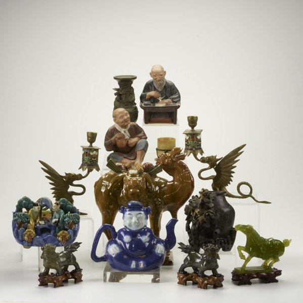 ASIAN FIGURES: Thirteen pieces: hardstone dragons, horse, and libation cup; reticulated soapstone vase; bronze vase with Dragon; Pair of brass and enamel winged griffin candlesticks; Tang style Camel; Planter with s