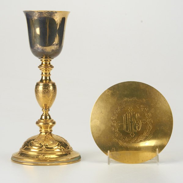 COMMUNION CHALICE AND HOST DISH: Two pieces, 20th C.: Gilt silver vessel on chased gilt brass column above gilt brass pedestal with raised and chased religious motifs, 10 1/4"; sterling vermeil dish, 5 1/2"; 5 OT