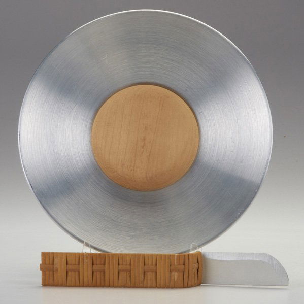 RUSSEL WRIGHT: Knife and cutting board, USA c.1940; Aluminum, birch, rattan; Stamped RUSSEL WRIGHT; Board 8" dia.