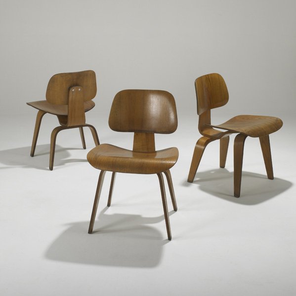 CHARLES AND RAY EAMES; HERMAN MILLER: Three dining chairs ( DCW's). USA, 1950s; Walnut and rubber; Impressed DCW; Each: 29" x 19 1/2" x 22"