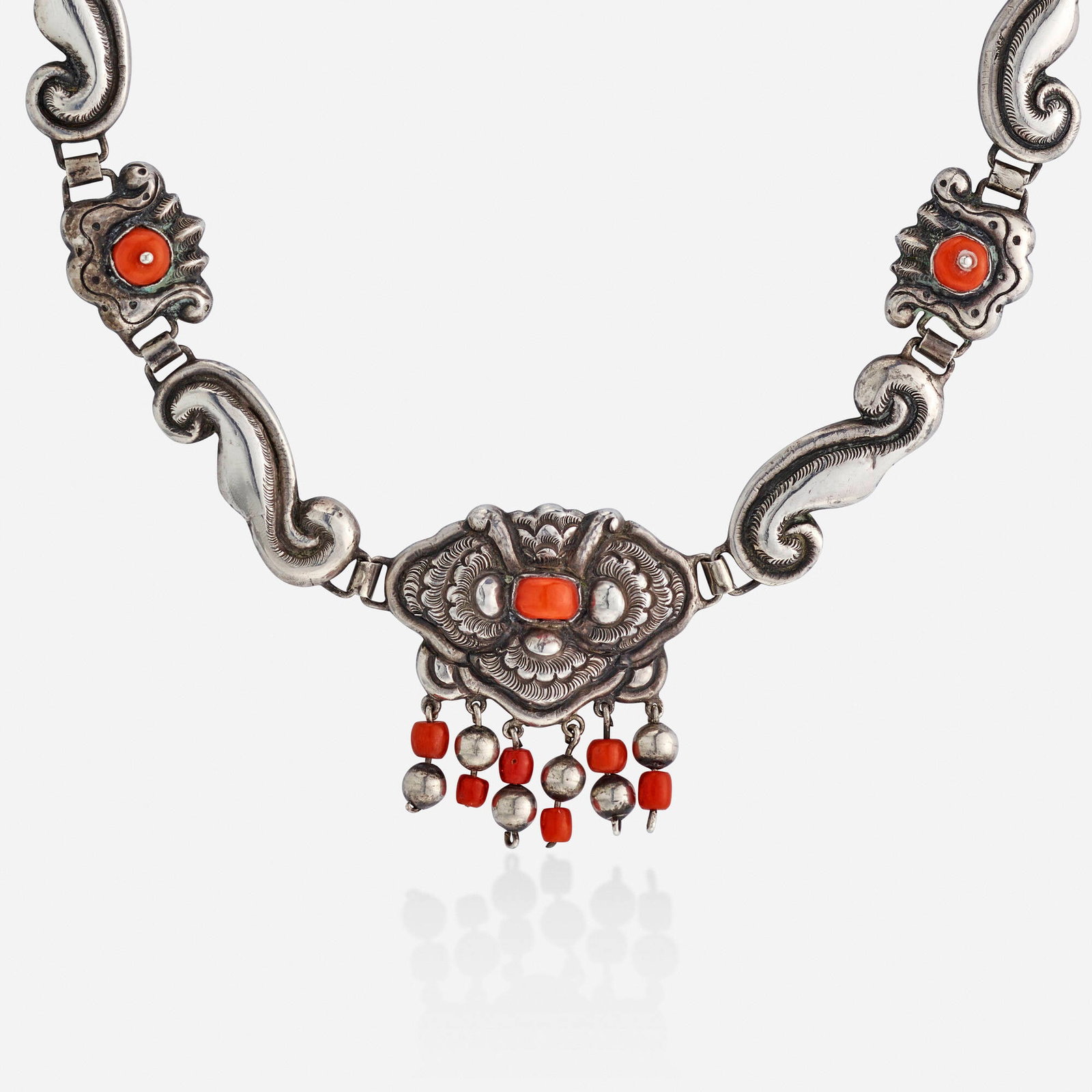 Matilde Poulat, Coral and silver necklace: Matilde Poulat Coral and silver necklace Of scrolling silver, set with beads of coral; 1940s Silver Signed Matl 16 in; Gross weight 33.7 dwts Provenance: Property of a Texas