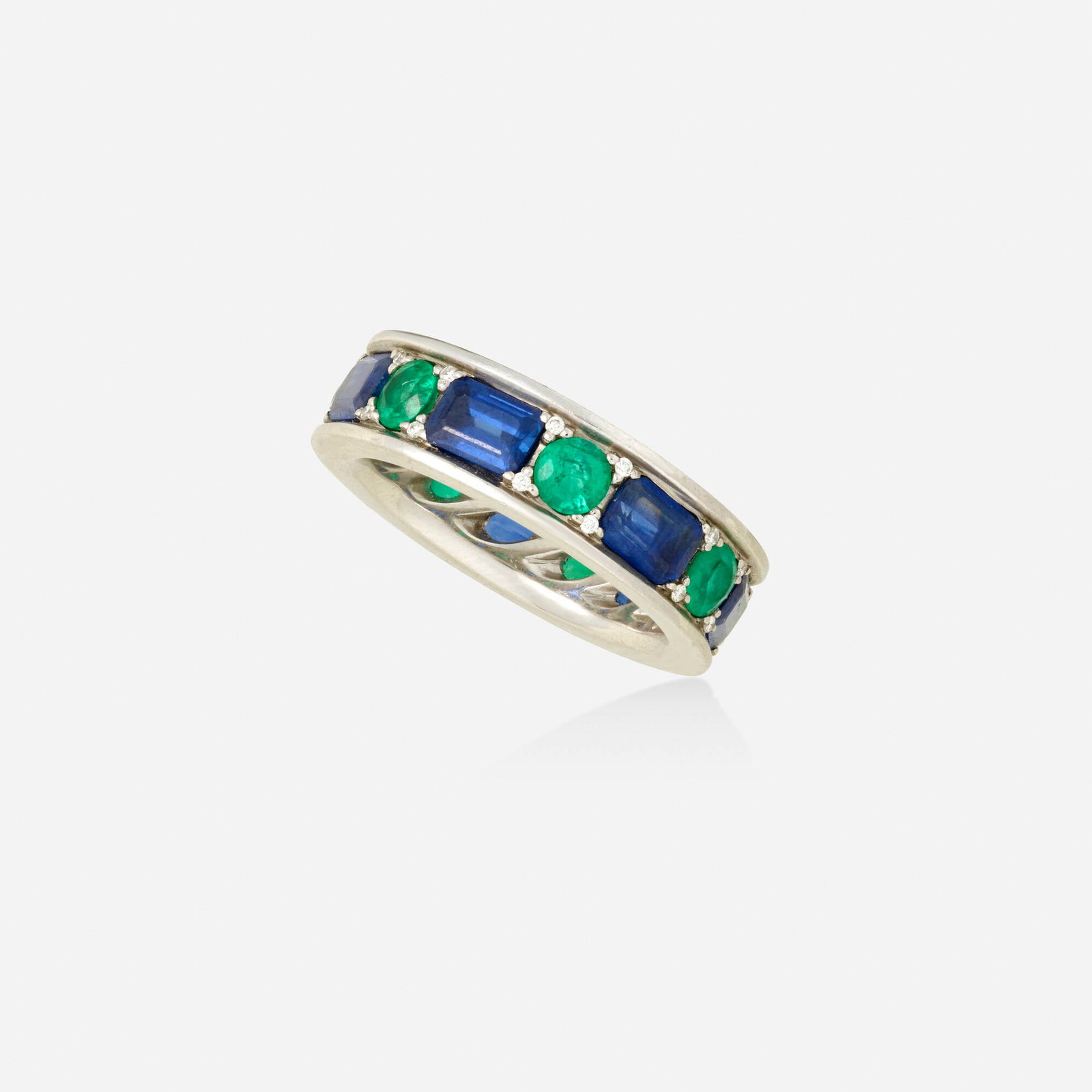 Sapphire, emerald, and diamond band ring: Sapphire, emerald, and diamond band ring Set with alternating rectangular-cut sapphires, circular-cut emeralds, and round brilliant-cut diamonds Platinum Ring size 7.25; Gross weight 10.6 dwts This wo