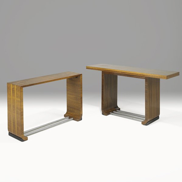 GILBERT ROHDE Two console tables: GILBERT ROHDE; HERMAN MILLER; Two tables, one with flip top, Zeeland, MI, 1930s; Paldao wood, ebonized wood, brushed metal; Foil labels; Larger: 29" x 56" x 16" (closed), smaller: 27 1/2" x 32" x 12"