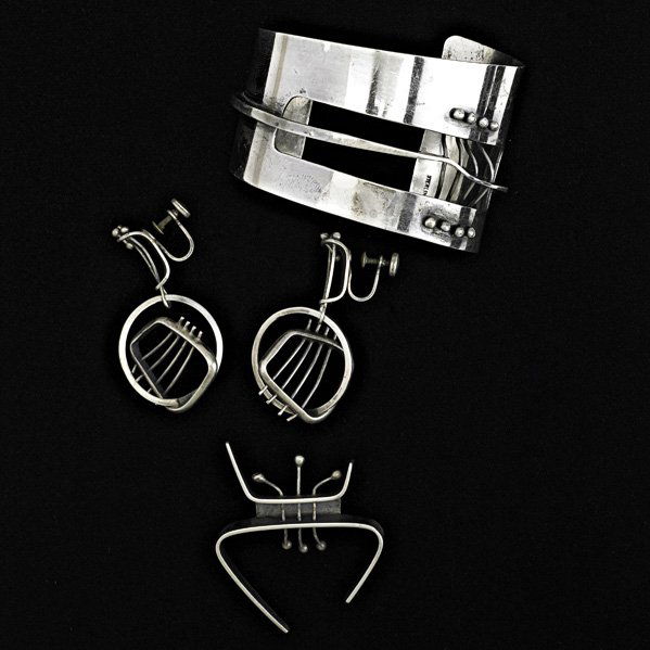 ED WIENER (1918-1991) Sculptural silver jewelry: ED WIENER (1918-1991); Sculptural sterling silver cuff bracelet, pair of earrings, and brooch, New York, 1950s; Bracelet and brooch both stamped ED WIENER STERLING, earrings stamped STERLING; Cuff: 1