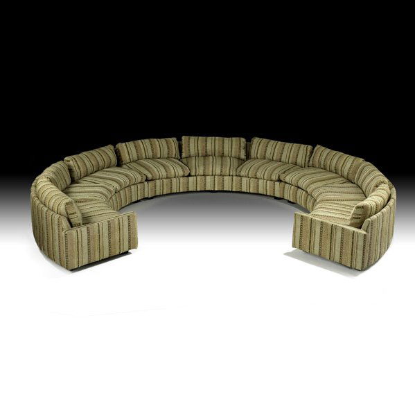 MILO BAUGHMAN Three-piece sectional sofa: MILO BAUGHMAN; THAYER COGGIN; Three-piece sectional circular sofa, High Point, NC, 1970s; Woven wool, ebonized wood; Upholstery labels; 29" x 164" dia.