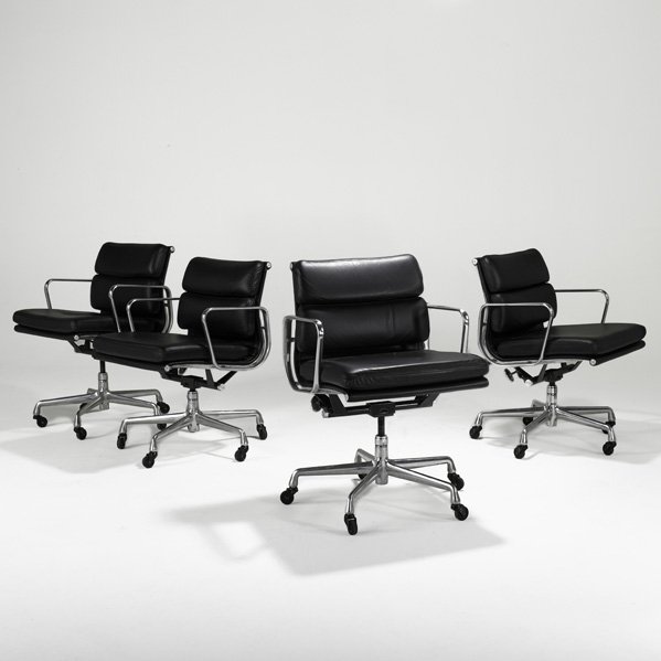 CHARLES AND RAY EAMES Four Soft Pad chairs: CHARLES AND RAY EAMES; HERMAN MILLER; Four Soft Pad chairs, Zeeland, MI, 2000s; Leather, polished aluminum, enameled metal, casters; Manufacturer's paper labels; 34" x 23" x 24"