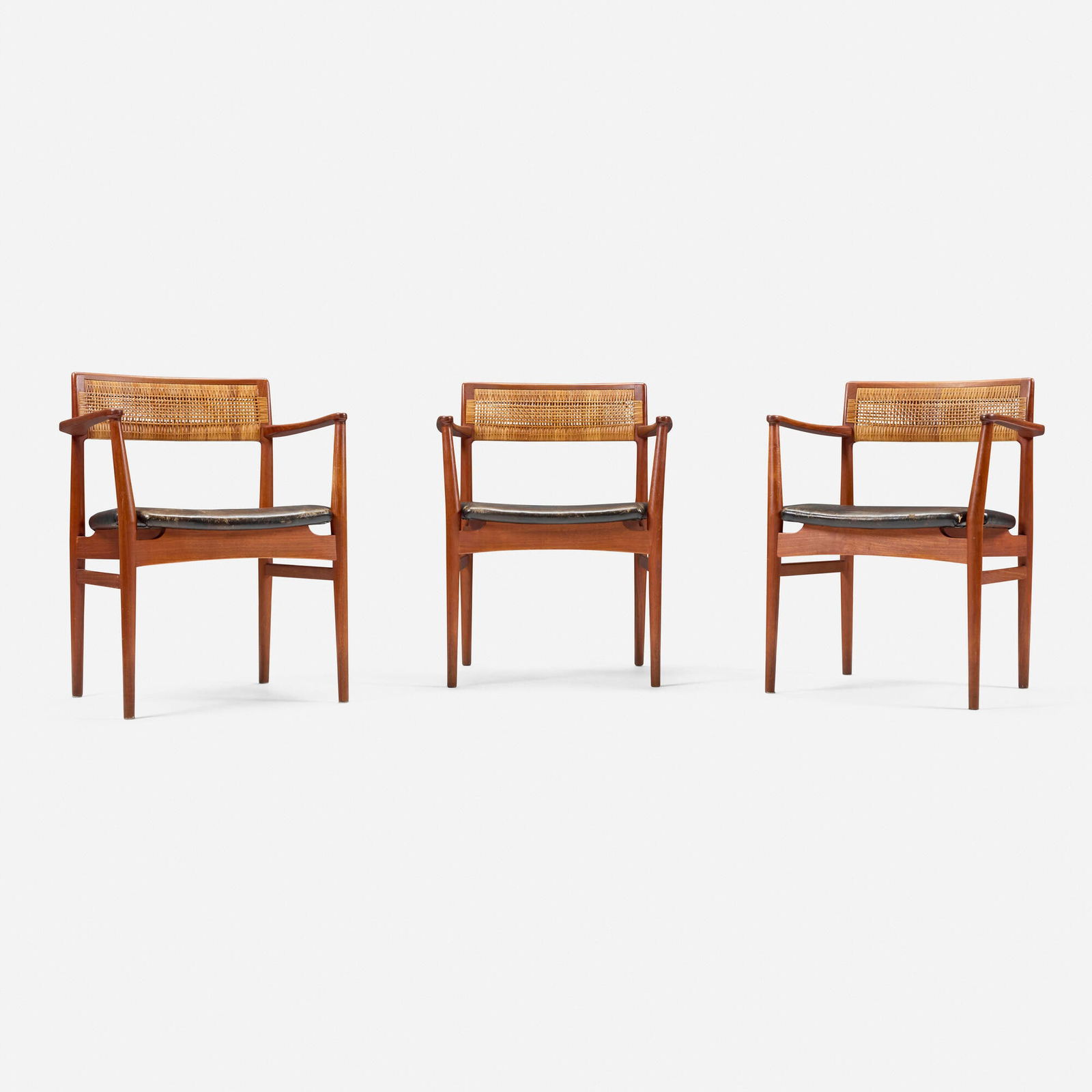 Erik Worts, Armchairs, set of three: Erik Worts Armchairs, set of three Henrik Worts MobelsnedkeriDenmark, c. 1955teak, cane, leather upholstery 30.25 h x 24 w x 18.25 d in (77 x 61 x 46 cm) Stamped manufacturer's mark to u