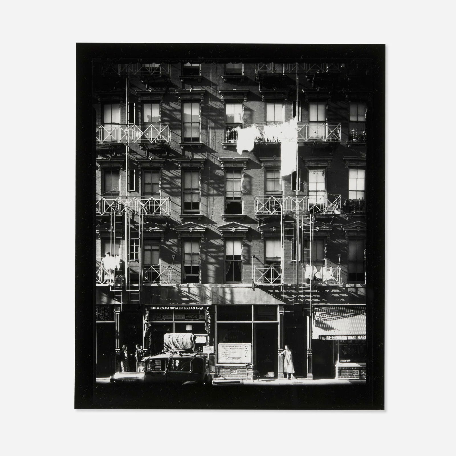 Walker Evans, Tenement Building: Walker Evans Tenement Building with Ground Floor Shops and Parked Car on Carmine Street, New York City 1934 / printed 1971gelatin silver print image: 7.875 h x 6.375 w in (20 x 16 cm) sheet: 10 h