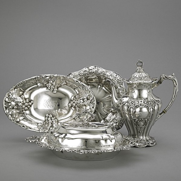 AMERICAN SILVER ORNATE HOLLOWARE, ca. 1900: Gorham rococo coffee pot, 1 3/4"; Redlich double covered vegetable bowl with detachable fancy ring finial, 13 1/2"; Mauser grape vine repousse oval bread bowl, 11"; J.E. Caldwell floral repousse round