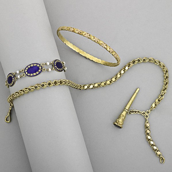 GOLD JEWELRY, 1880-1920: Three items: concentric 14k gold floral bangle by Jabel, 2 3/8" interior; enameled 14k gold and seed pearl bracelet, 6 1/4"; Dutch 14k gold watch chain and key. 33.9 dwt. (52.7 gs.)