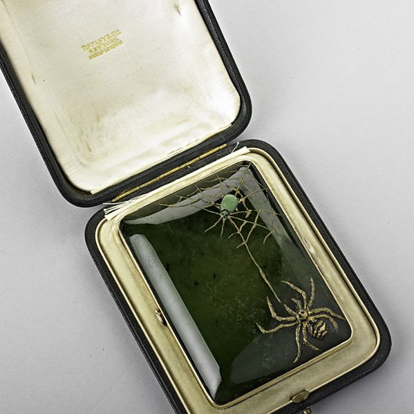 TIFFANY & CO. GOLD NEPHRITE CIGARETTE CASE: Cushion form, the cover ornamented with a spider and his prey (possibly later addition), ca. 1900. In original case. Marked Tiffany & Co. 14k. 3 7/16" x 2 5/8"