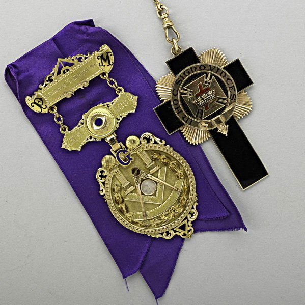 GOLD MASONIC JEWELS, MORRISTOWN, NJ, ca. 1920: Two pieces presented to Lawrence M. Christensen: 14k gold master badge with purple ribbon and carved moonstone by Dieges & Clust, No. 188, 3 7/8", in case; enameled cross by Riker, 2 3/4" on chain, 54
