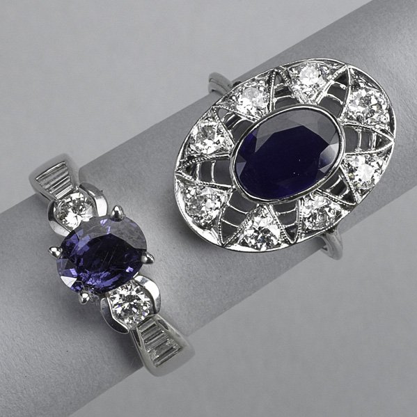 TWO JEWELED 18K WHITE GOLD RINGS: Oval faceted sapphire framed by circular cut diamonds on knife edge filigree; color-change garnet flanked by circular cut and baguette cut diamond channels. Diamonds approx. 1.90 cts. TW; sapphire app