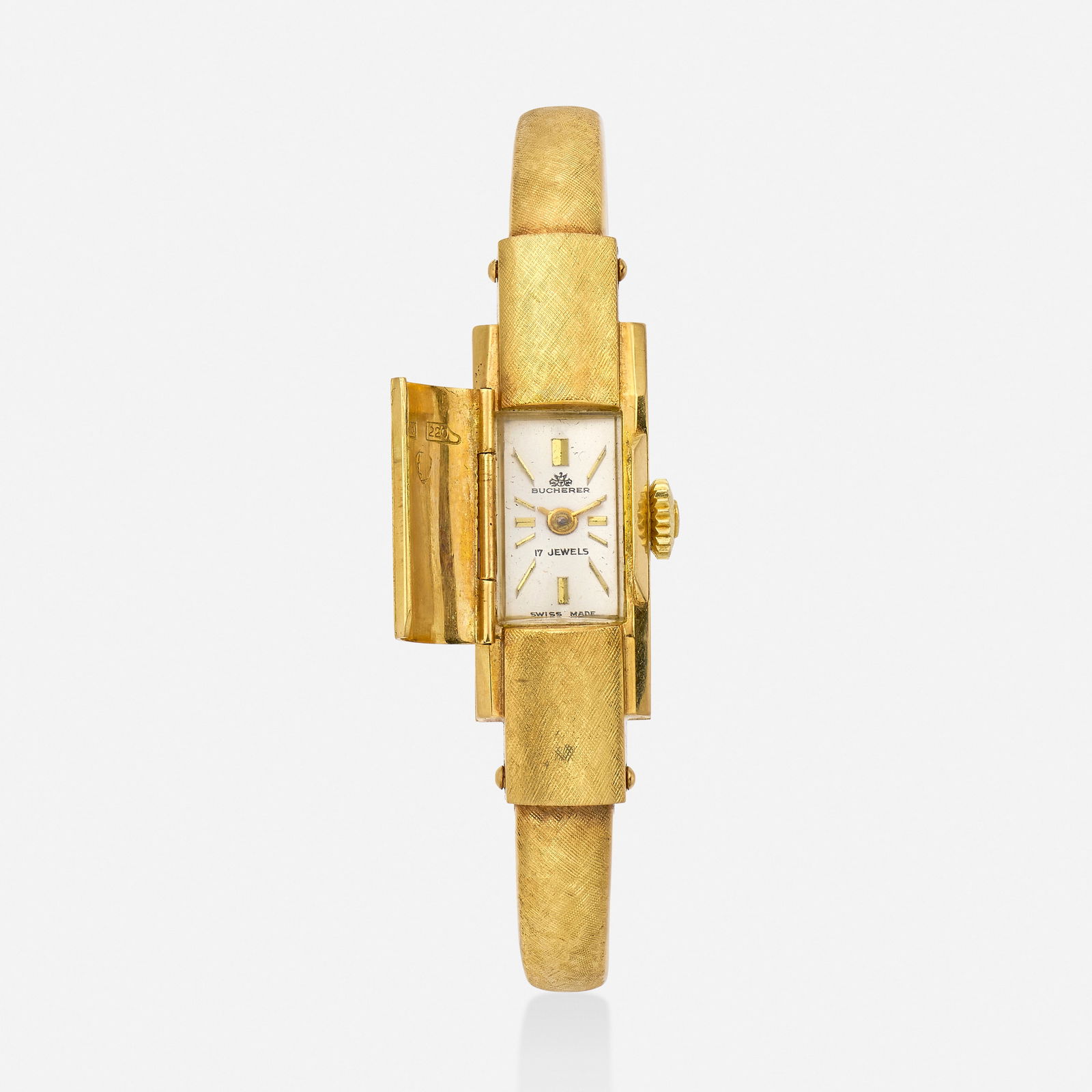 Bucherer, Gold bracelet watch: Bucherer Gold bracelet watch With baton hours, textured gold cover case and bangle bracelet Dial: Silvered Movement: Manual wind Case material: 18k yellow gold Case size: