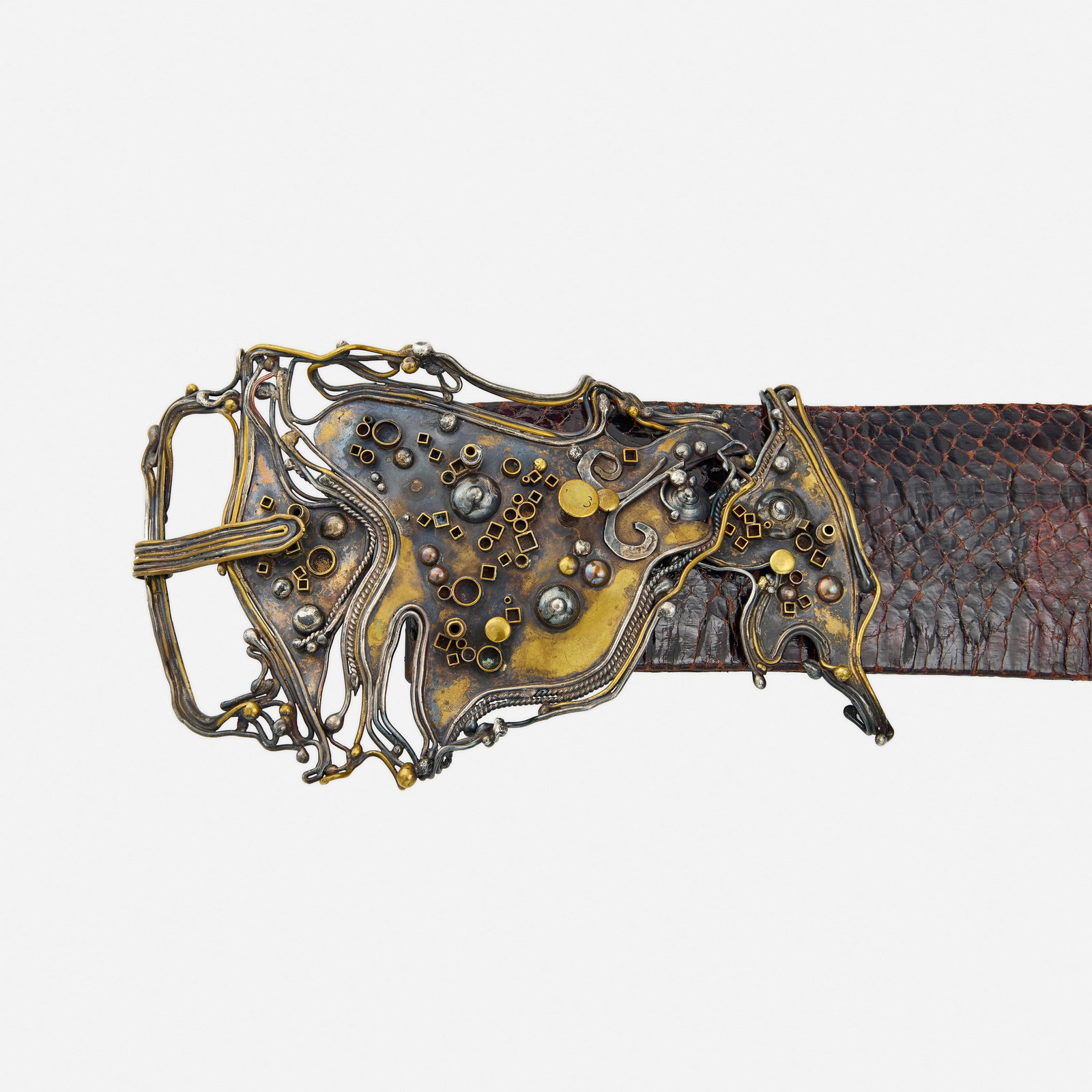 Marci Zelmanoff, Mixed-metal and leather belt: Marci Zelmanoff Mixed-metal and leather belt The buckle of abstract design, to the brown leather belt; 1976 Silver, brass, and copper Signed Zelmanoff 40.50 in x 4 in; Gross weight 196.1 dwts