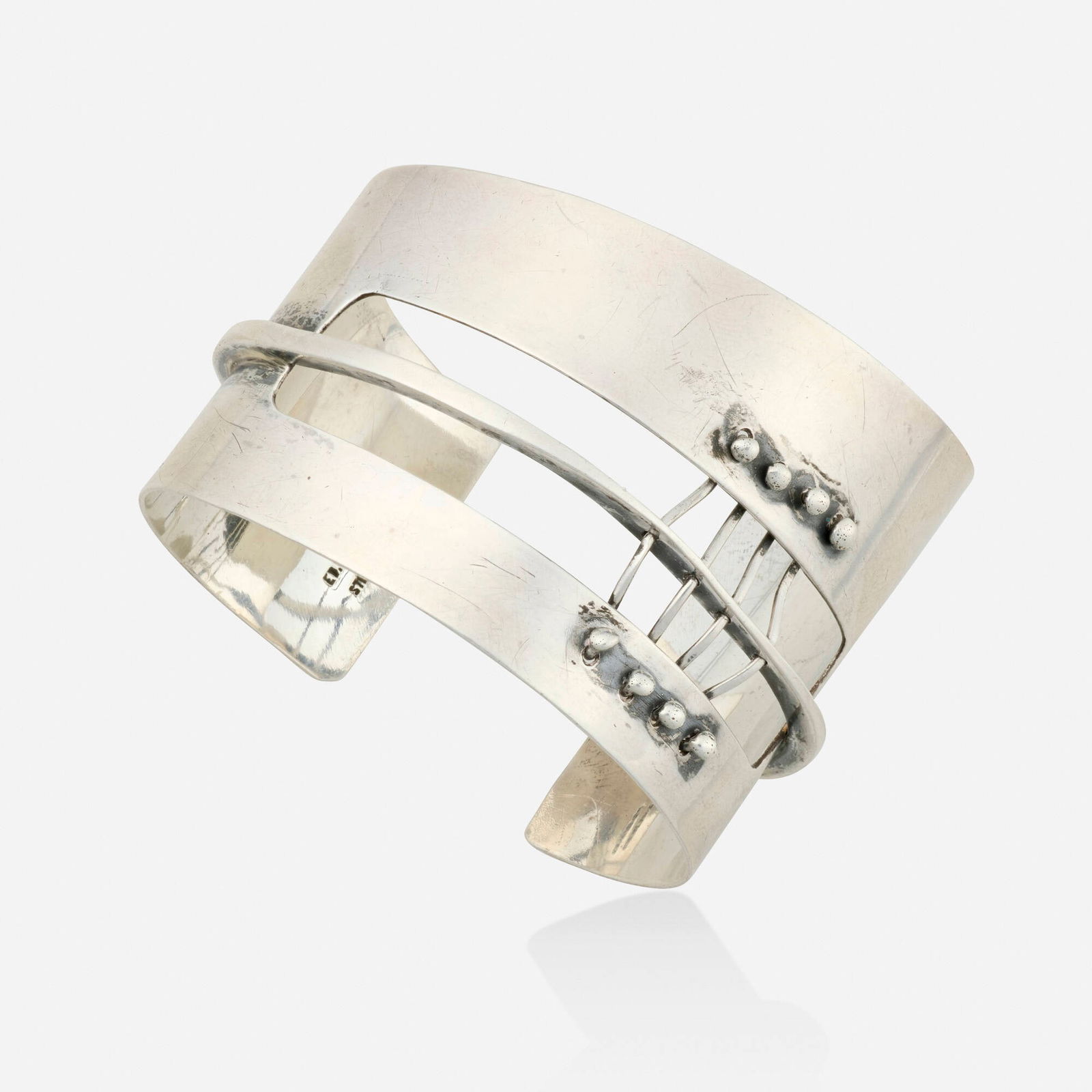 Ed Wiener, Sterling silver cuff bracelet: Ed Wiener Sterling silver cuff bracelet Of abstract design; 1950s Sterling silver Signed Ed Wiener Inner circ. 6.50 in, width 1.875 in; Gross weight 32.7 dwts This work will