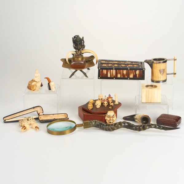 CURIOSITIES: Twenty-four pieces including inkwell, netsukes, magnifying glass, boxes, pipes, 20th c.; Bone, ivory, porcupine quill, brass, leather, ebony, horn, silver-plate, glass and resin; Some marked; Magnifyi