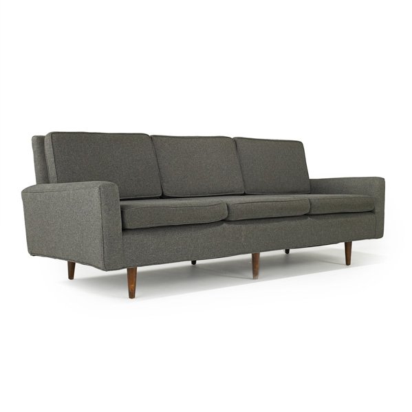 FLORENCE KNOLL; KNOLL ASSOCIATES: Sofa, USA, 1950s; Upholstery and stained maple; Unmarked; 31" x 90" x 32"
