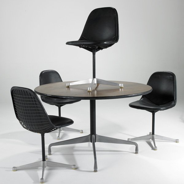 CHARLES AND RAY EAMES; HERMAN MILLER: Dining table and four wire chairs, USA, 1960s; Rosewood, cast aluminum, vinyl, and enameled metal; Table: 29" x 48" dia., Chairs: 33" x 19" x 21"