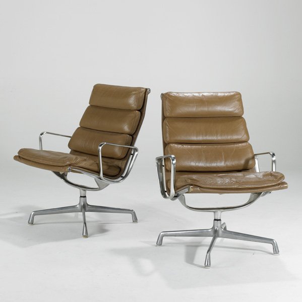 CHARLES AND RAY EAMES; HERMAN MILLER: Pair of Soft Pad swivel lounge chairs, Zeeland, MI, 1980s; Leather and cast aluminum; Paper label; Each: 34" x 25" x 27"