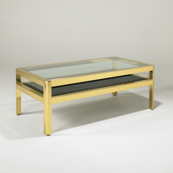 KARL SPRINGER: Coffee table, USA, 1980s; Polished brass, glass, acrylic and felt; Unmarked; 19" x 52" x 28 1/2"