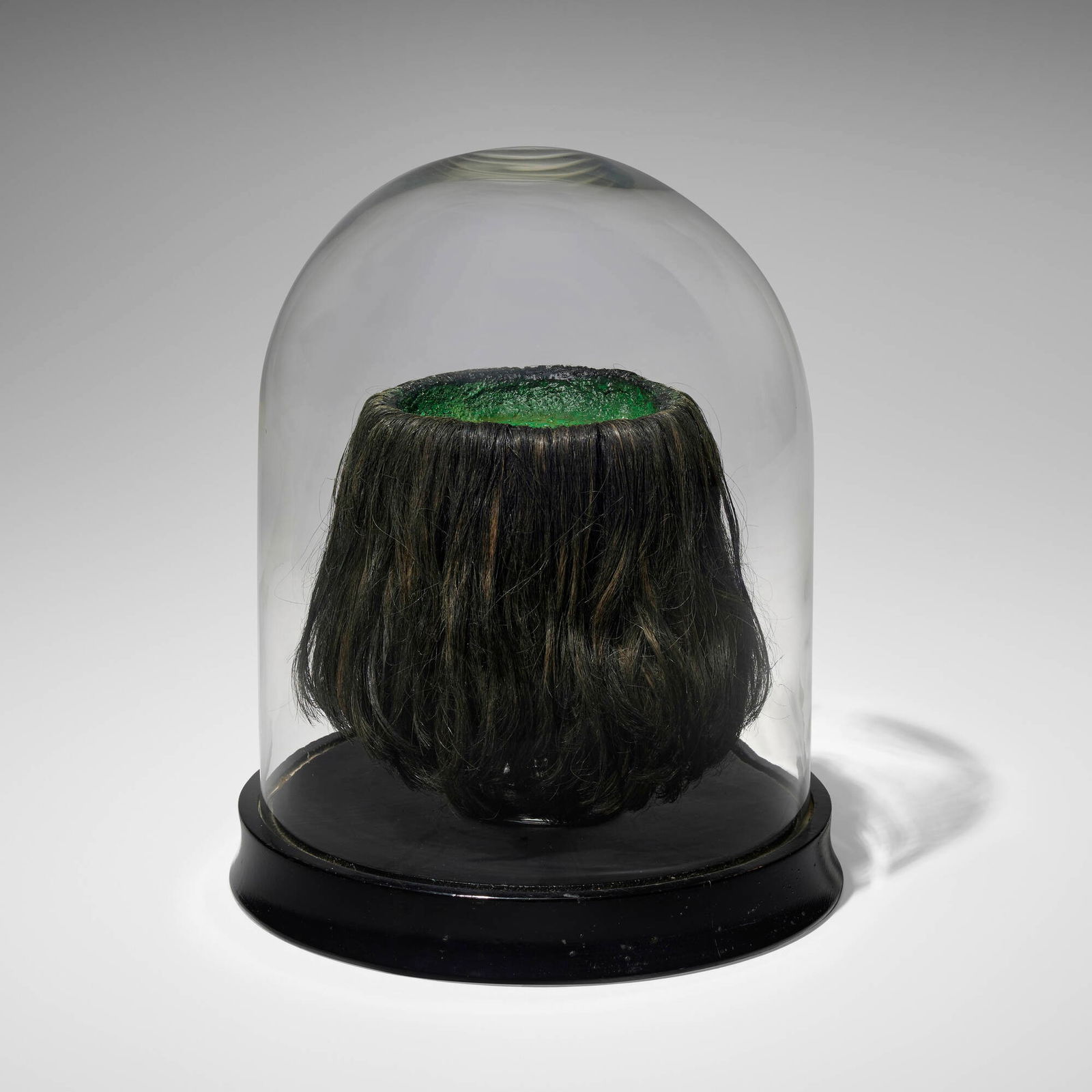 Mike Kelley, Kappa Scalp: Mike Kelley Kappa Scalp 1985mixed media and toupee, wine glass, glass dome, painted wood 13.5 h x 10.75 dia in (34 x 27 cm) Provenance: Rosamund Felsen Gallery, Los Angeles |
