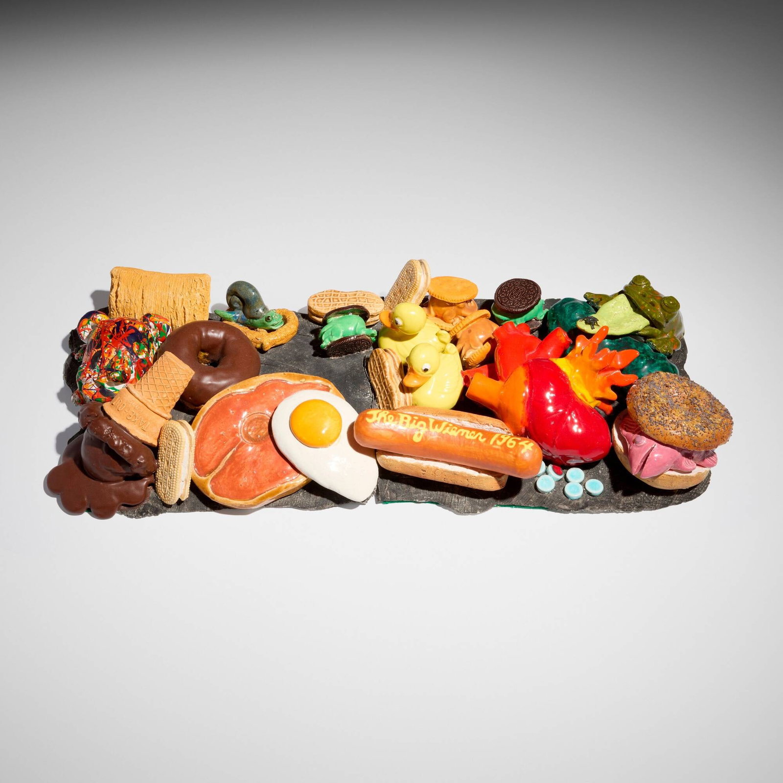 David Gilhooly, The Big Wiener 1964: David Gilhooly The Big Wiener 1964 1990glazed earthenware 3.5 h x 22.5 w x 9.5 d in (9 x 57 x 24 cm) Signed and dated to underside of one element 'David Gilhooly 1990'. Provenan