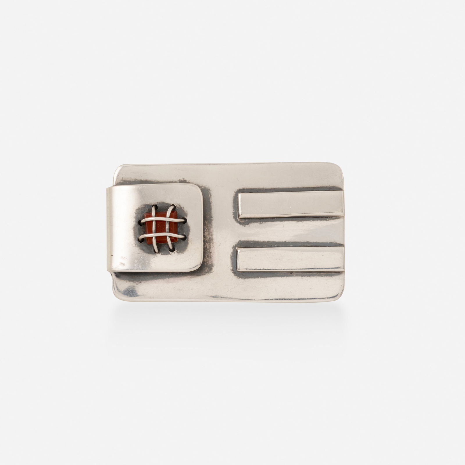 Sam Kramer, Carnelian and sterling silver brooch: Sam Kramer Carnelian and sterling silver brooch Of rectangular outline, set with a caged carnelian Sterling silver Signed with maker's mark for Sam Kramer 2.25 x 1.25 in; Gross weight 19.6 dwts<