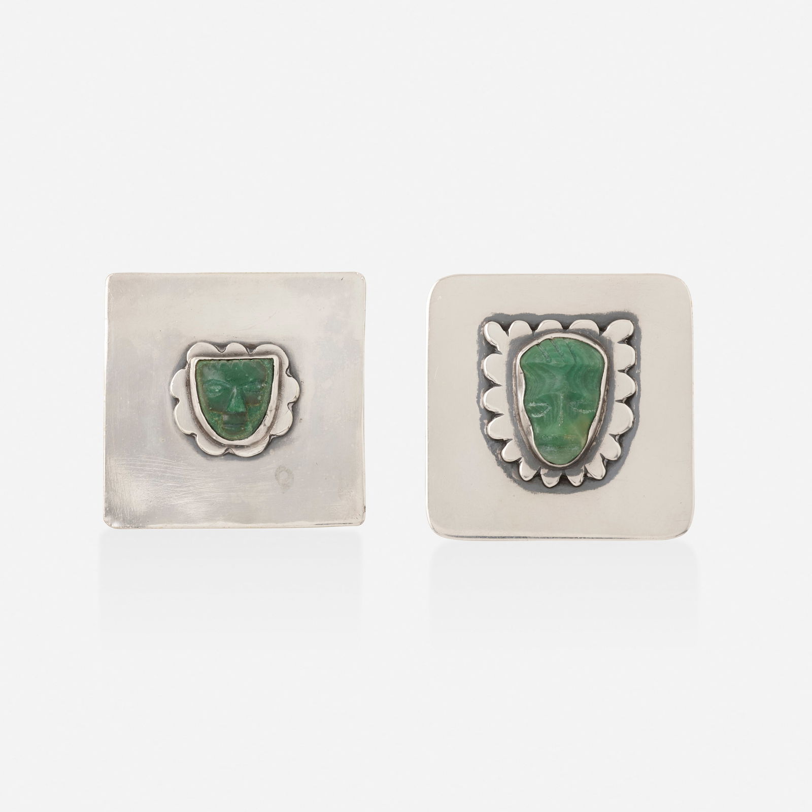 Sam Kramer, Two nephrite jade and sterling silver brooches: Sam Kramer Two nephrite jade and sterling silver brooches Each set with a carved nephrite jade face Sterling silver Signed with maker's mark for Sam Kramer to each example Each 1.875 x 1.875 in;