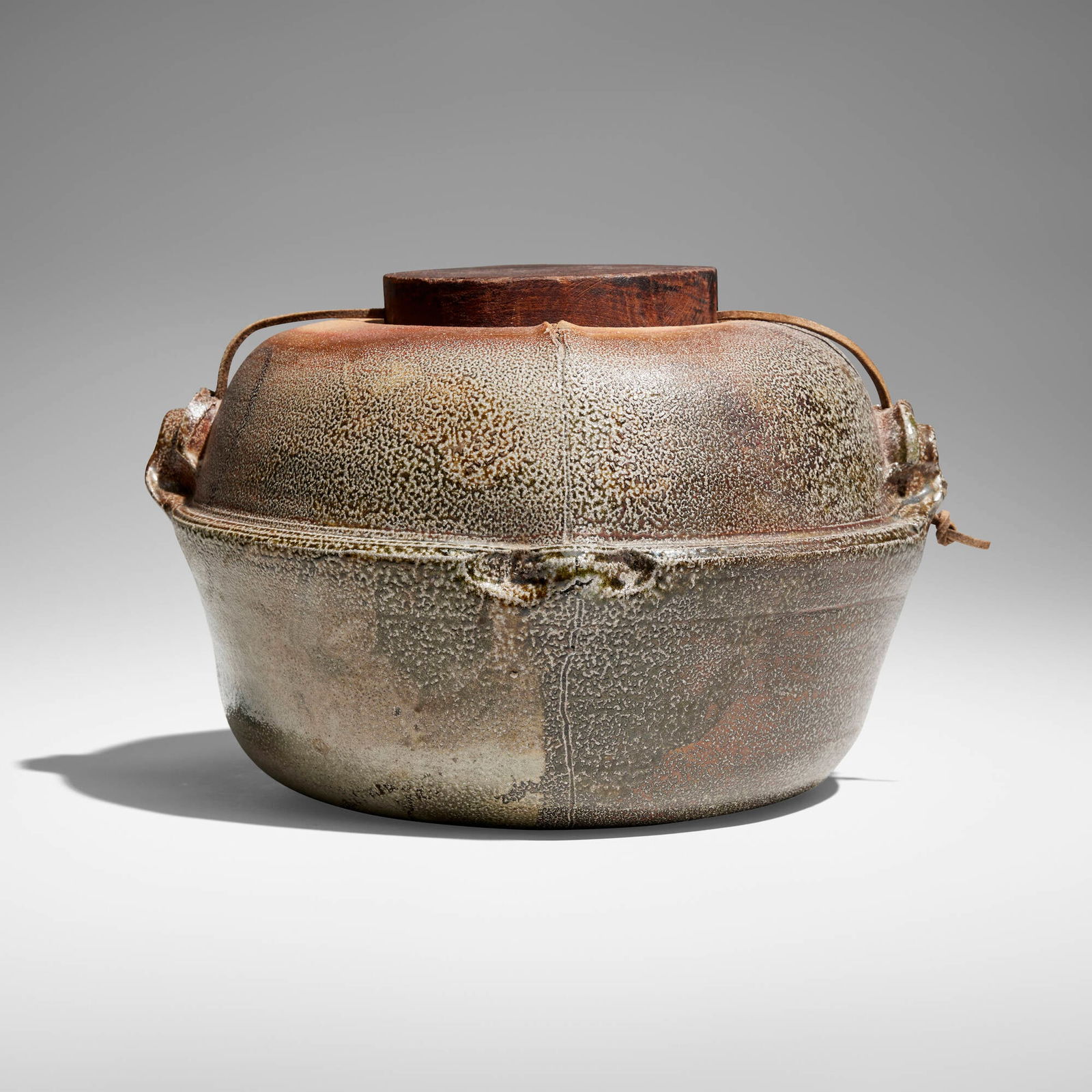 Sandra Johnstone, Covered jar: Sandra Johnstone Covered jar c. 1975glazed stoneware, leather, wood 7.5 h x 11.25 w x 10.75 d in (19 x 29 x 27 cm) Incised signature to underside 'Johnstone'. Provenance: