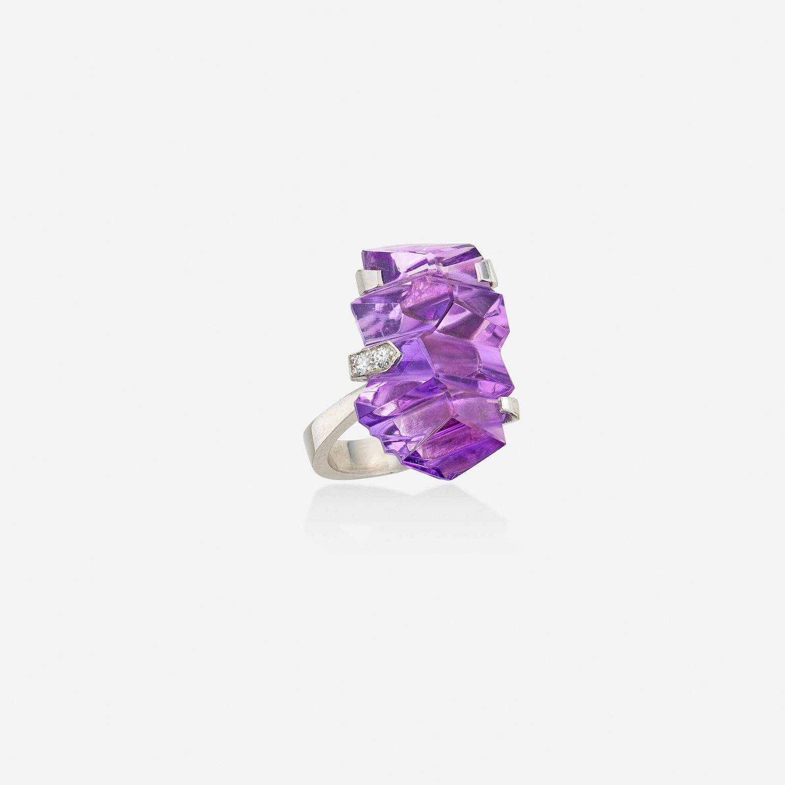 Andrew Grima, Amethyst, diamond, and white gold ring: Andrew Grima Amethyst, diamond, and white gold ring Set with a fancy-cut amethyst cut by Bernd Munsteiner, the prongs set with round brilliant-cut diamonds; 1971 18k white gold Signed Grima Ring siz