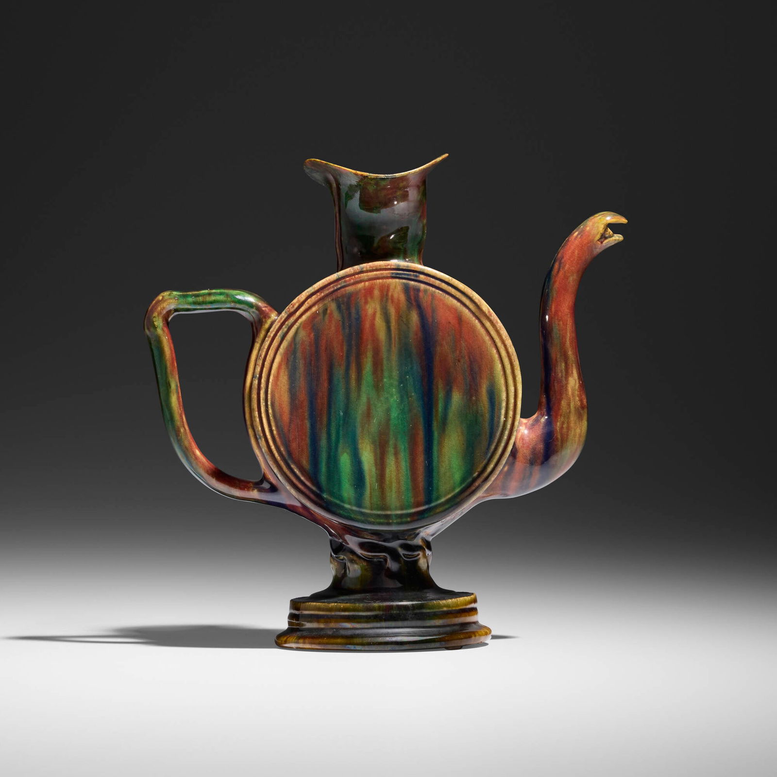 George E. Ohr, Rare cadogan teapot: George E. Ohr Rare cadogan teapot USA, 1895-1903glazed earthenware 9.25 h x 9 w x 4 d in (23 x 23 x 10 cm) Cadogan features a flask form and twisted stem with an emerald, indigo, and raspberry