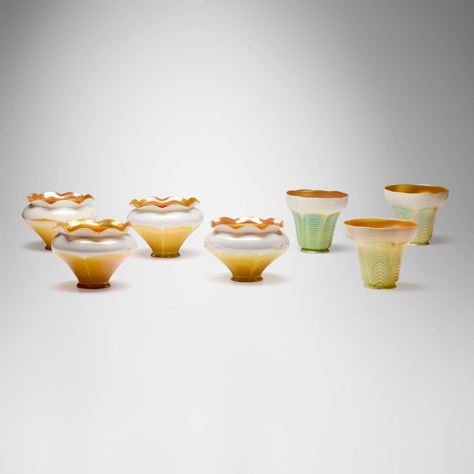 Steuben, attribution, Collection of seven pulled-feather shades: Steuben, attribution Collection of seven pulled-feather shades USA, c. 1910hand-blown glass 4.5 h x 5 dia in (11 x 13 cm) 4.25 h x 5.5 dia in (11 x 14 cm) Remants of stamped manufacturer's